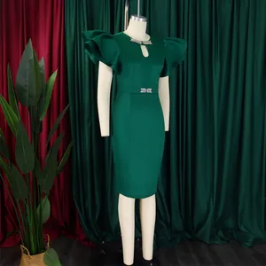 Detail of dark green bodycon dress with layered ruffle sleeves and rhinestone accents