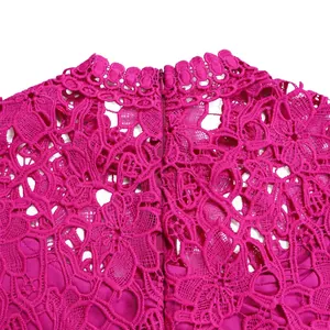 Detailed macro shot of intricate fuchsia lace fabric with hollow-out pattern and zipper