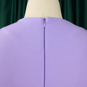 Close-up detail showing the back invisible zipper on an elegant purple long sleeve dress