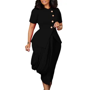 Detail of a chic black two-piece African set featuring a buttoned top and draped skirt.