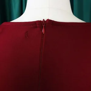Macro view of the invisible back zipper and neckline on a burgundy commuter dress