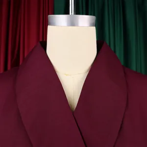 Macro detail showing the elegant burgundy shawl collar on a stylish plus size dress