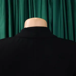 Vue arrière détaillée d'une robe noire à col blazer sur un mannequin avec fond vert