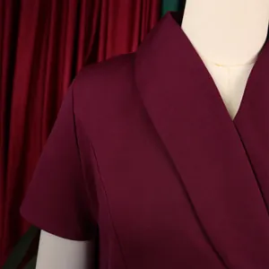 Detail view of wine red elegant plus size dress with a unique wrap collar design