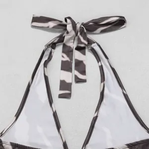 Close-up of adjustable halter neck tie on zebra print jumpsuit showing fabric detail
