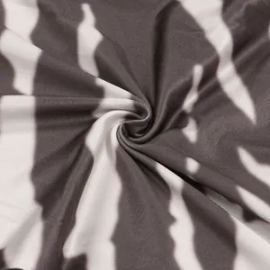 Detailed close-up showing the soft texture and black and white tie-dye pattern of stretch fabric
