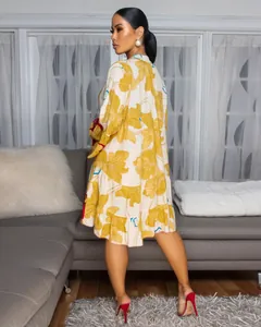 Elegant loose floral print V-neck mini dress with contrast trim shown from the back