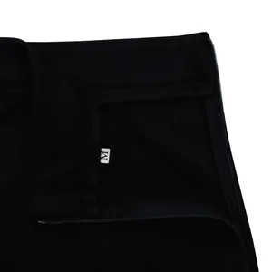 Close-up view of a black skirt waistband featuring a side zipper and a size M label tag