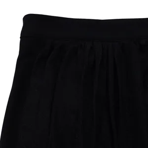 Close-up of black elastic waistband and pleated fabric detail on elegant skirt