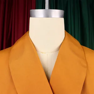 Close-up of mustard yellow shawl collar on an elegant plus size African dress for women.