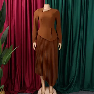 Full view of elegant brown long sleeve dress with asymmetrical neckline and pleated skirt.