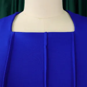 Close-up detail of a royal blue dress featuring a square neckline and vertical pleats