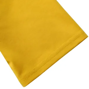 Macro detail showing high-quality yellow fabric stitching for elegant women's top