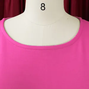 Macro view of hot pink crew neckline showing fine stitching and textured fabric detail
