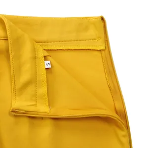 Close-up view of elegant yellow skirt waist showing zipper and size tag 'S' details