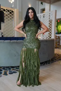 Close-up of elegant green sequined mesh patchwork dress with ruffled skirt detail