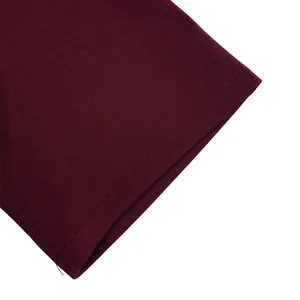 High-quality stitching detail on the burgundy fabric of a short-sleeve dress hem