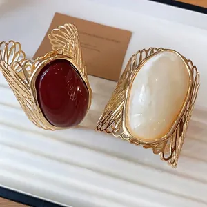 Vintage gold hollow metal cuff bracelet with large oval resin stone statement jewelry accessory
