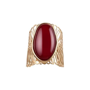 Elegant vintage gold openwork metal cuff bracelet featuring a large oval red stone for women.