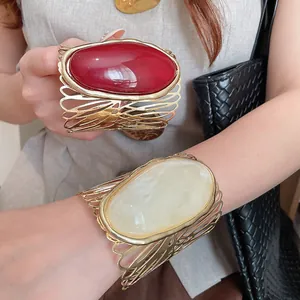 Vintage gold hollow metal cuff bracelet with large oval resin stone detail for women