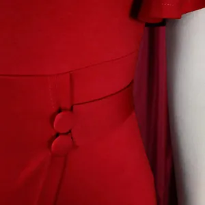 Close-up detail of red high-waist office dress showing fabric texture and buttons