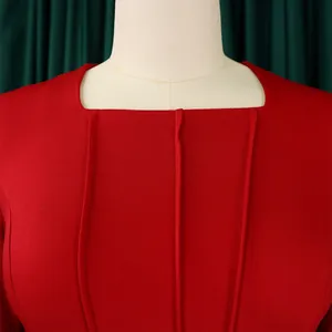 Close-up of red elegant dress featuring a square neckline and vertical seam detailing