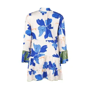 Elegant floral print tiered mini dress with green flared cuffs shown from the back