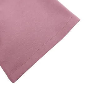 Macro view showing the neat stitching and soft pink fabric texture of this African dress