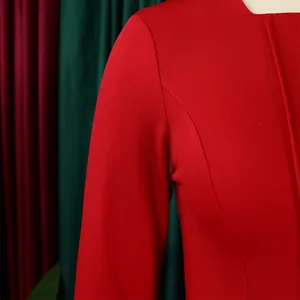 Detailed close-up of the shoulder and sleeve construction of a red elegant dress.