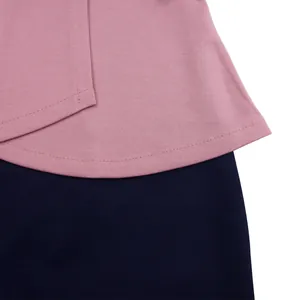 Detailed close-up showing the mauve and navy blue stitching of an elegant African dress.
