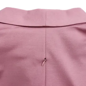 Close-up detail of the hidden zipper and fine fabric texture on a pink elegant dress