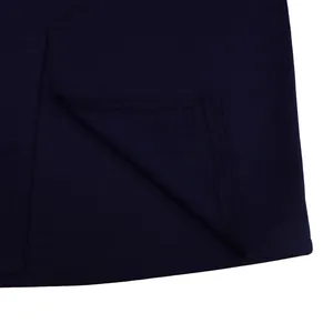Close-up of the professional hem stitching and slit detail on a navy blue bodycon dress