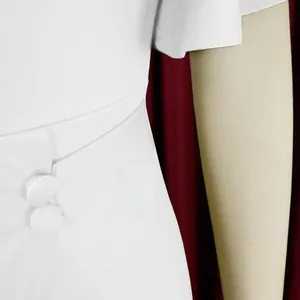 Detail of a white high-waisted office dress featuring elegant ruffle sleeves and buttons.