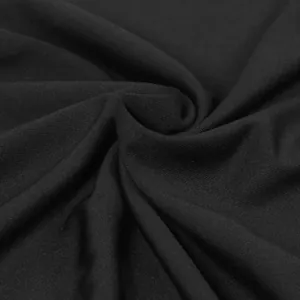 Close-up van zwarte elastische gebreide stoftextuur voor een elegante lange rokset.