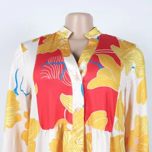 Close-up shot of an elegant floral print V-neck dress with colorful patchwork details.