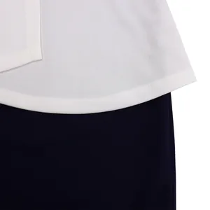 Close-up detail showing white curved hem and navy blue fabric on an elegant dress