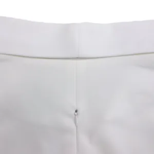 Detailed macro view showing the high-quality invisible zipper on a white bodycon dress