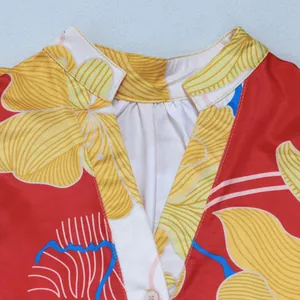 Close-up view of the V-neckline and vibrant floral print on an elegant summer dress.