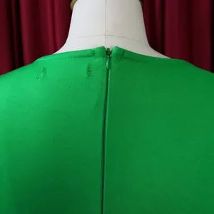 Detailed back view of a solid green office dress featuring a premium hidden zipper