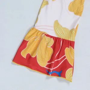 Close-up of elegant floral print flared sleeve detail on patchwork V-neck dress