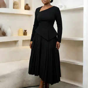 Close-up detail of black midi dress featuring elegant asymmetric neckline and pleated skirt