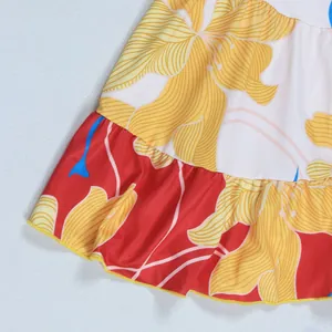 Detail of floral print mini dress showing vibrant yellow flowers and ruffle hem.