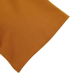 Detailed close-up of mustard yellow ribbed fabric with precise sleeve stitching