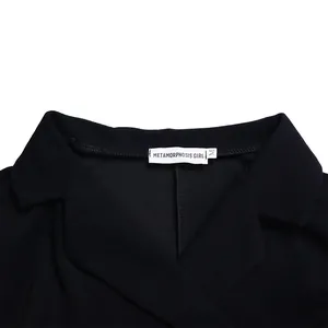 Vue détaillée de l'encolure de la robe noire avec l'étiquette Metamorphosis Girl
