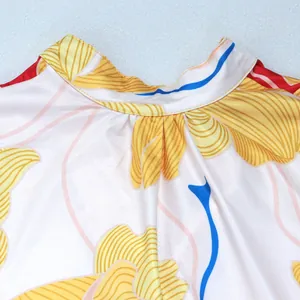 Macro view showing the elegant high neckline detail of floral print satin short dress