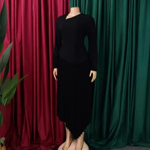 Elegant black long-sleeved dress with asymmetrical neckline and pleated skirt detail