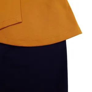 Detailed close-up showing stitching and fabric texture on a color block African dress.