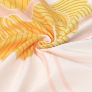 Macro detail of the soft fabric and elegant yellow floral print on a pink dress.