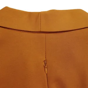 Macro shot of the high-quality concealed zipper on an orange African plus size dress.
