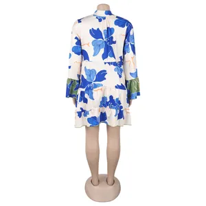 Back view of an elegant loose short dress with blue floral print and green accents